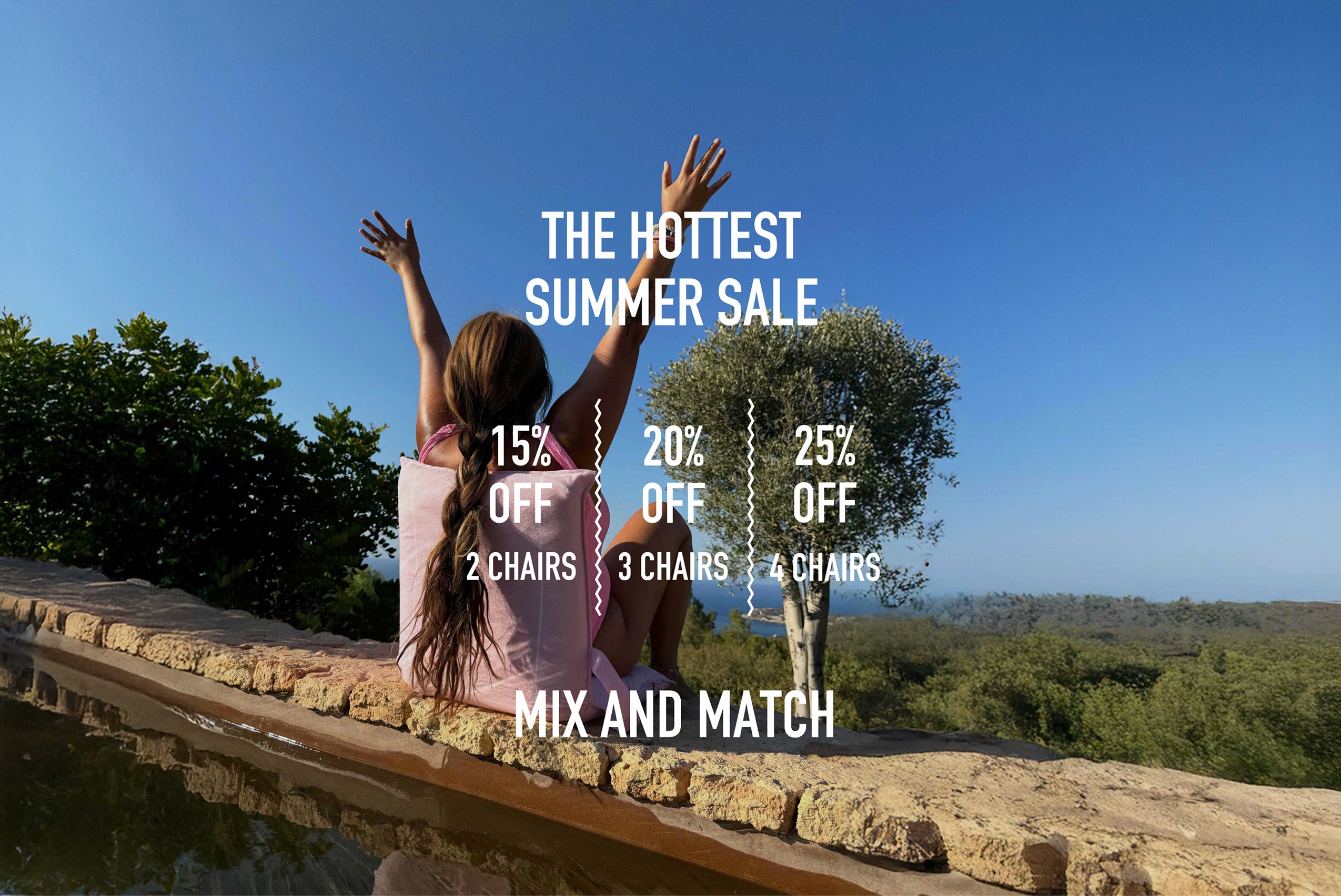 Pink folding beach chair from La Chaise featured in summer sale promo with scenic outdoor viewslider_item_gDytRX